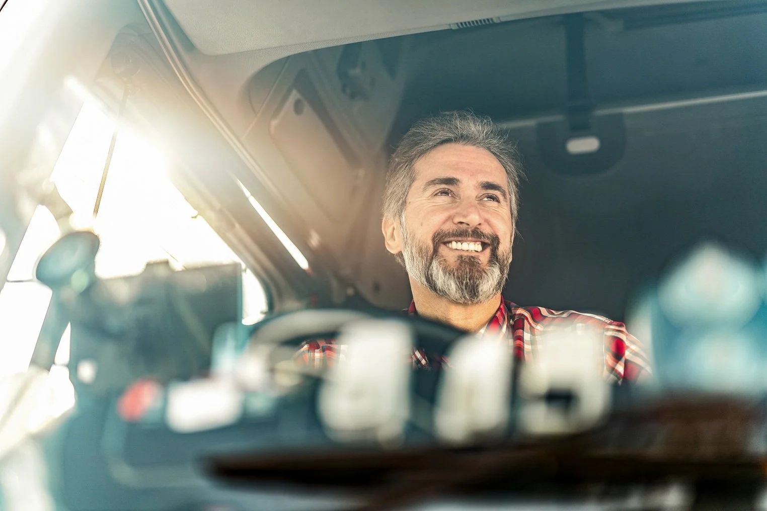 Truck driver smiling behind the wheel